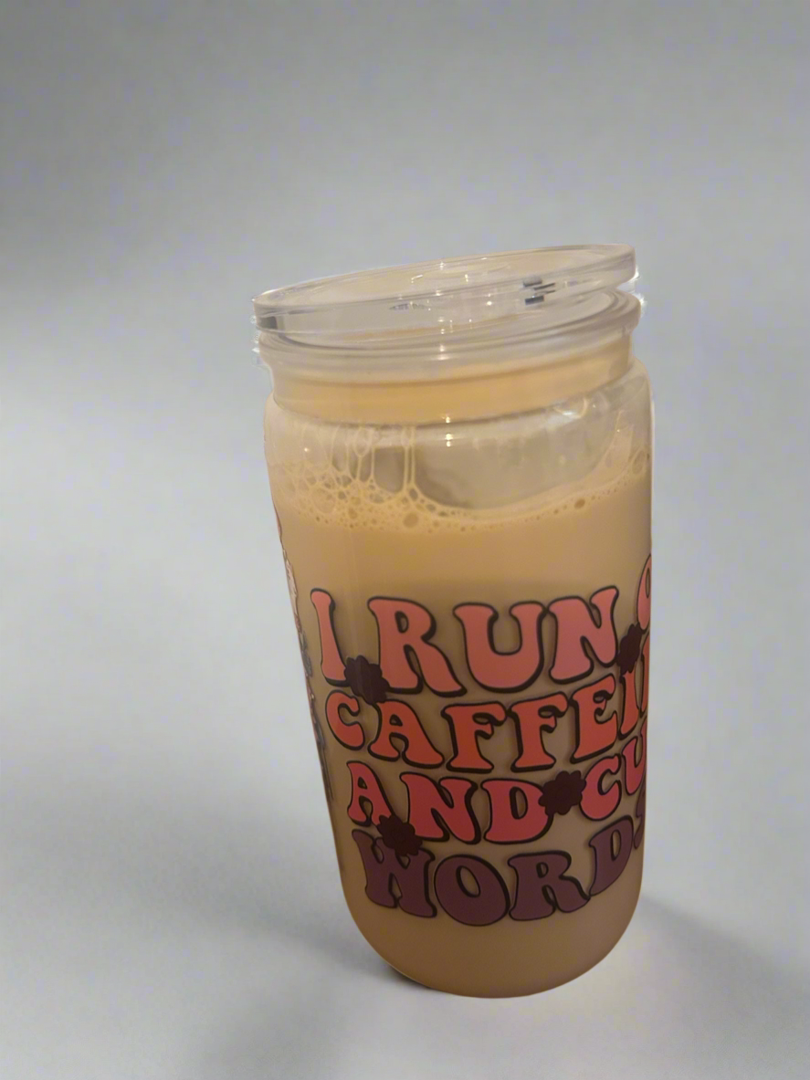 16 oz snow globe tumbler with the saying I Run On Caffeine And Cuss Words.